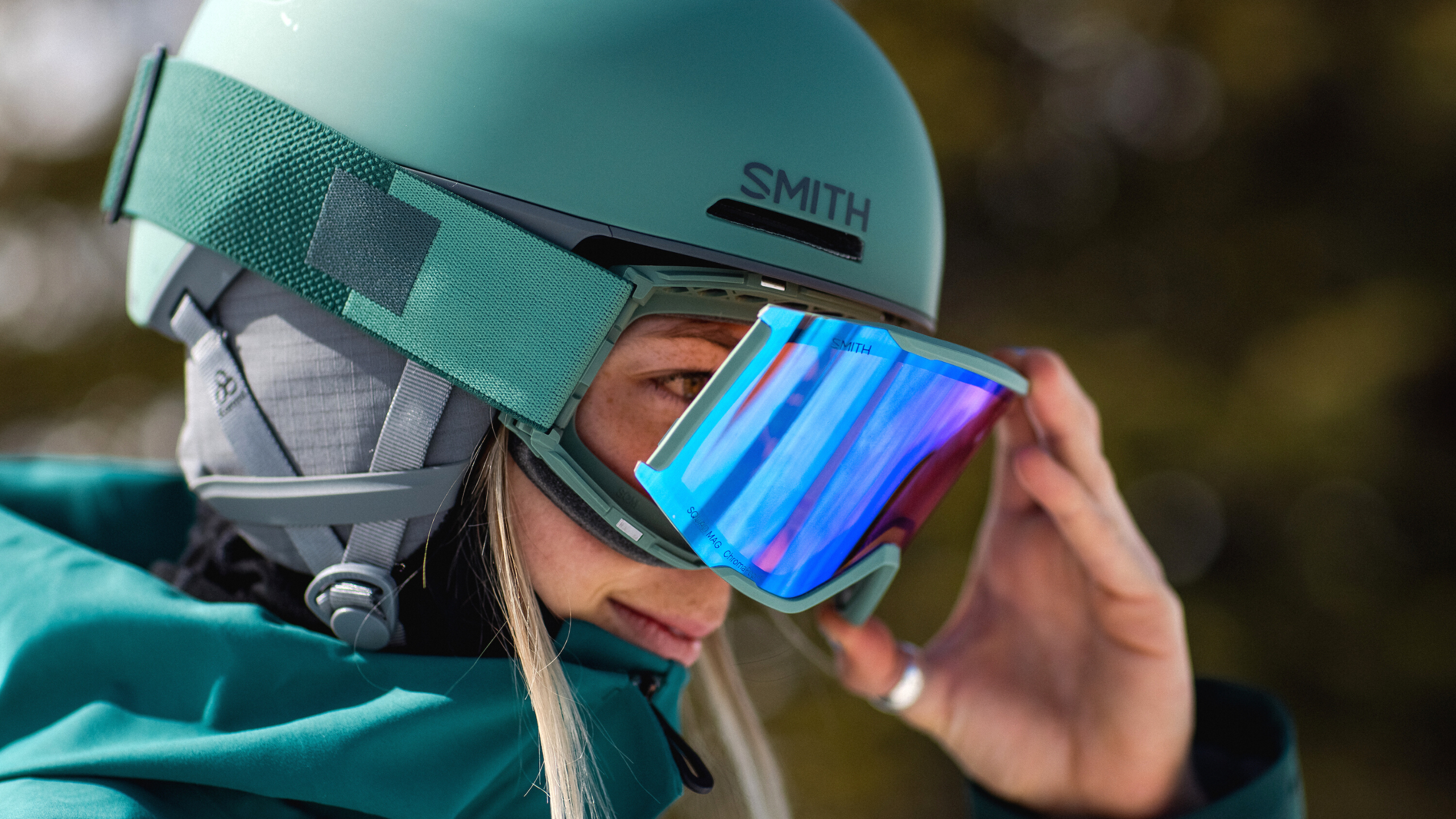 Andrea Byrne changing the lenses on Squad MAG goggle while wearing them.